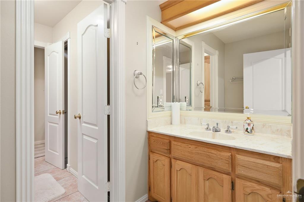 23725 North Val Verde Road Edinburg, TX 78542 - Photo 29 of 36 a bathroom with a shower sink vanity and mirror
