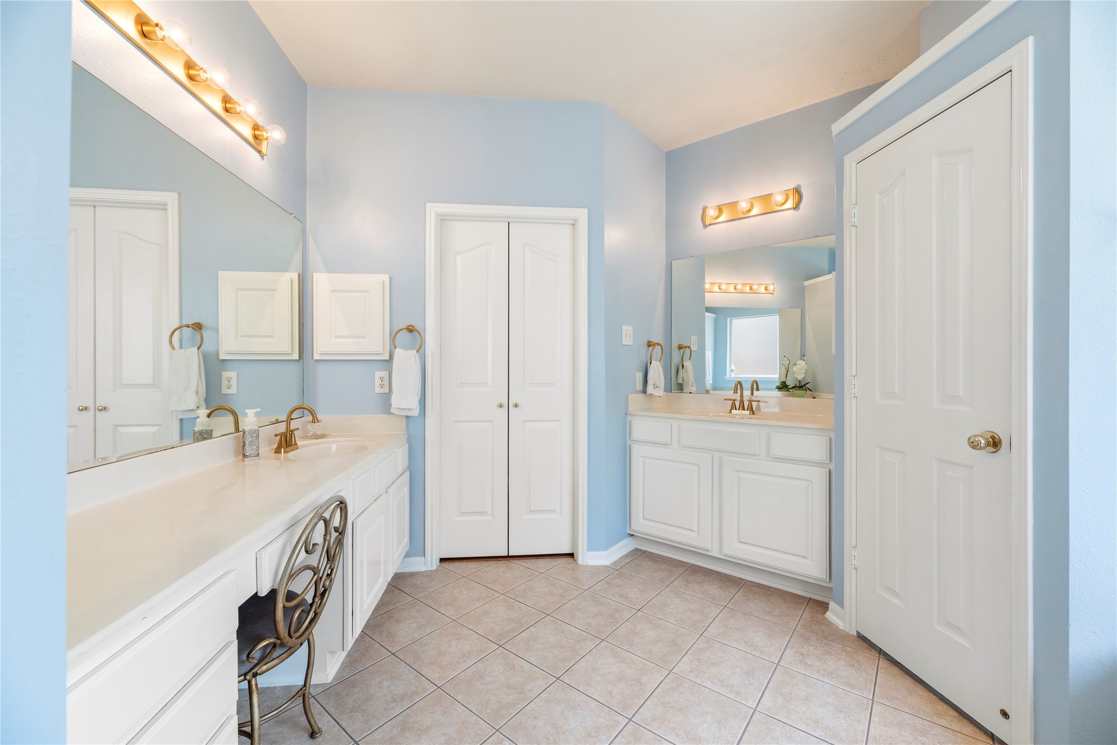 7930 Chateau Point Lane Houston, TX 77041 - Photo 19 of 34 Dual vanities with ample counter space and gold fixtures. Includes a seated makeup area and plenty of storage with multiple cabinets and a linen closet.