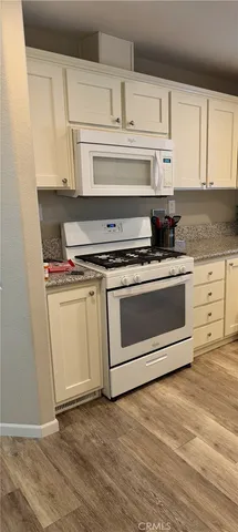 a stove top oven sitting inside of a kitchen