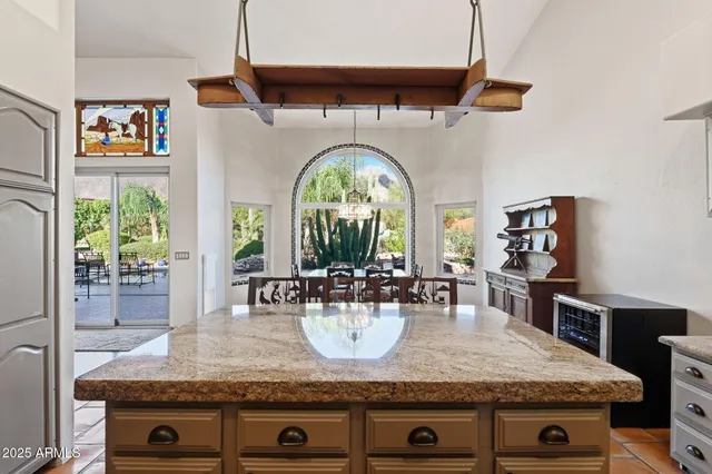 a bedroom with a large bed and a chandelier
