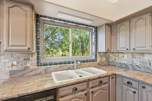 a living room with a bed furniture and a flat screen tv