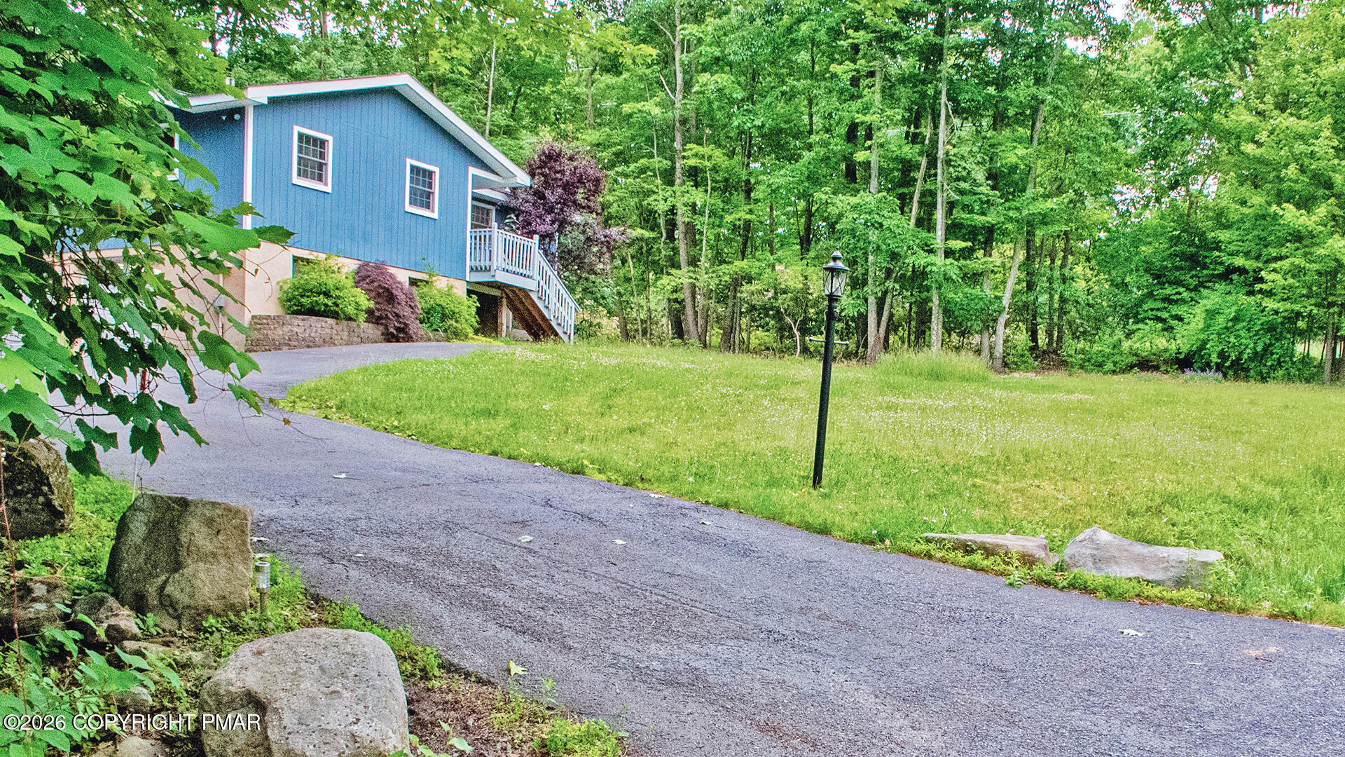 a view of a house with a yard and a garden