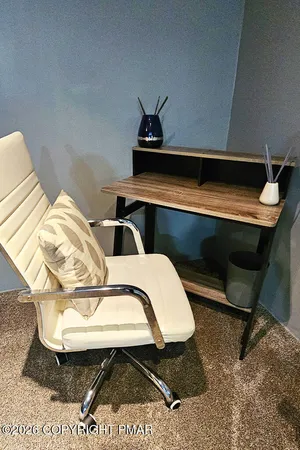 a bedroom with furniture and a rug