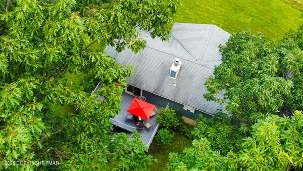an aerial view of a house with a yard