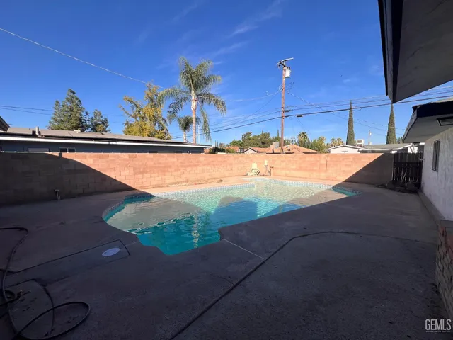 a view of a swimming pool with a yard