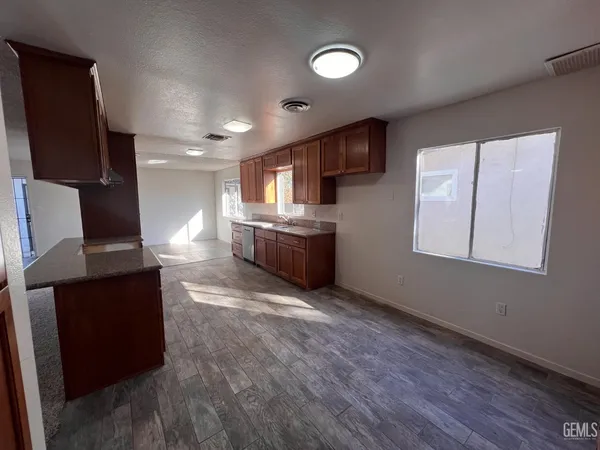 a kitchen with stainless steel appliances wooden cabinets and a refrigerator