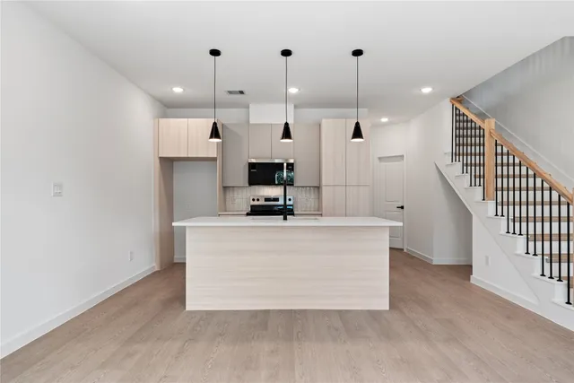 a view of living room with furniture and a ceiling fan