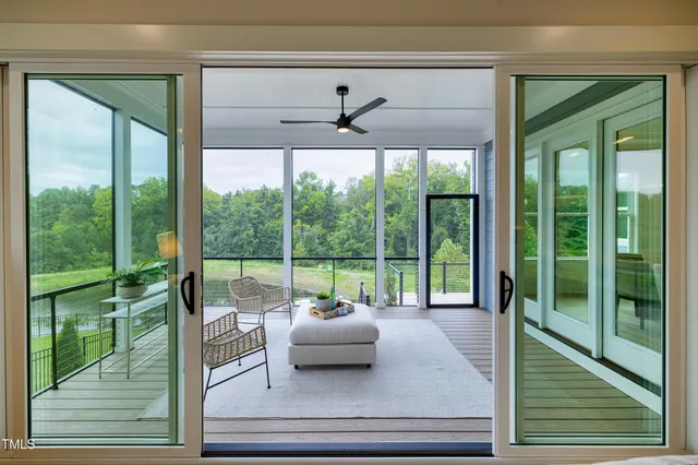 a kitchen with stainless steel appliances kitchen island granite countertop a stove a sink a refrigerator and white cabinets with wooden floor