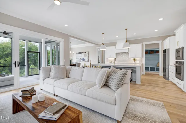 a dining room with furniture a chandelier and wooden floor