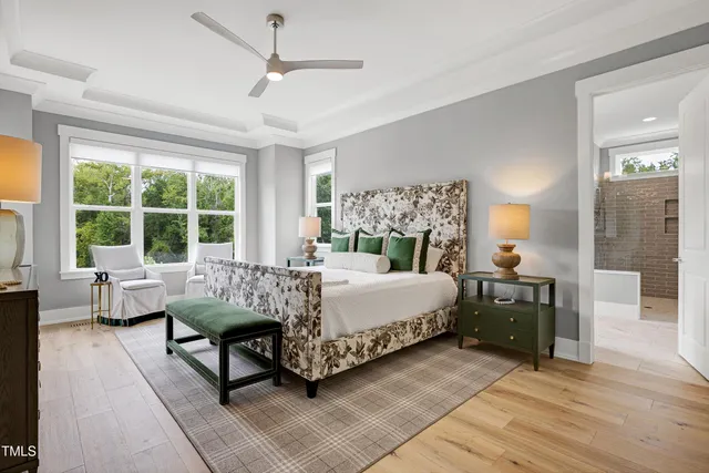 a bedroom with a bed table and chair