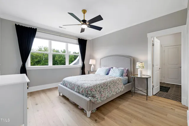 an aerial view of residential houses with outdoor space and parking