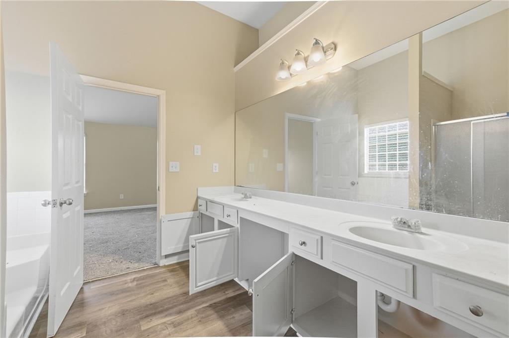 4968 Locherby Drive Fairburn, GA 30213 - Photo 33 of 39 a bathroom with a sink double vanity and a mirror