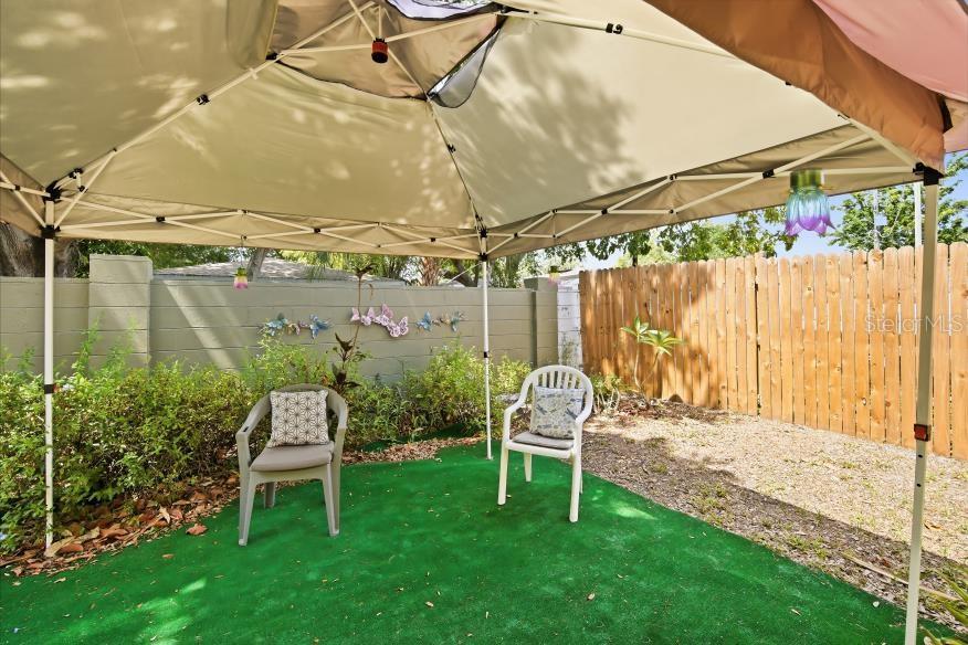 3005 West Chestnut Street Tampa, FL 33607 - Photo 23 of 27 a view of a chair and table in backyard of the house