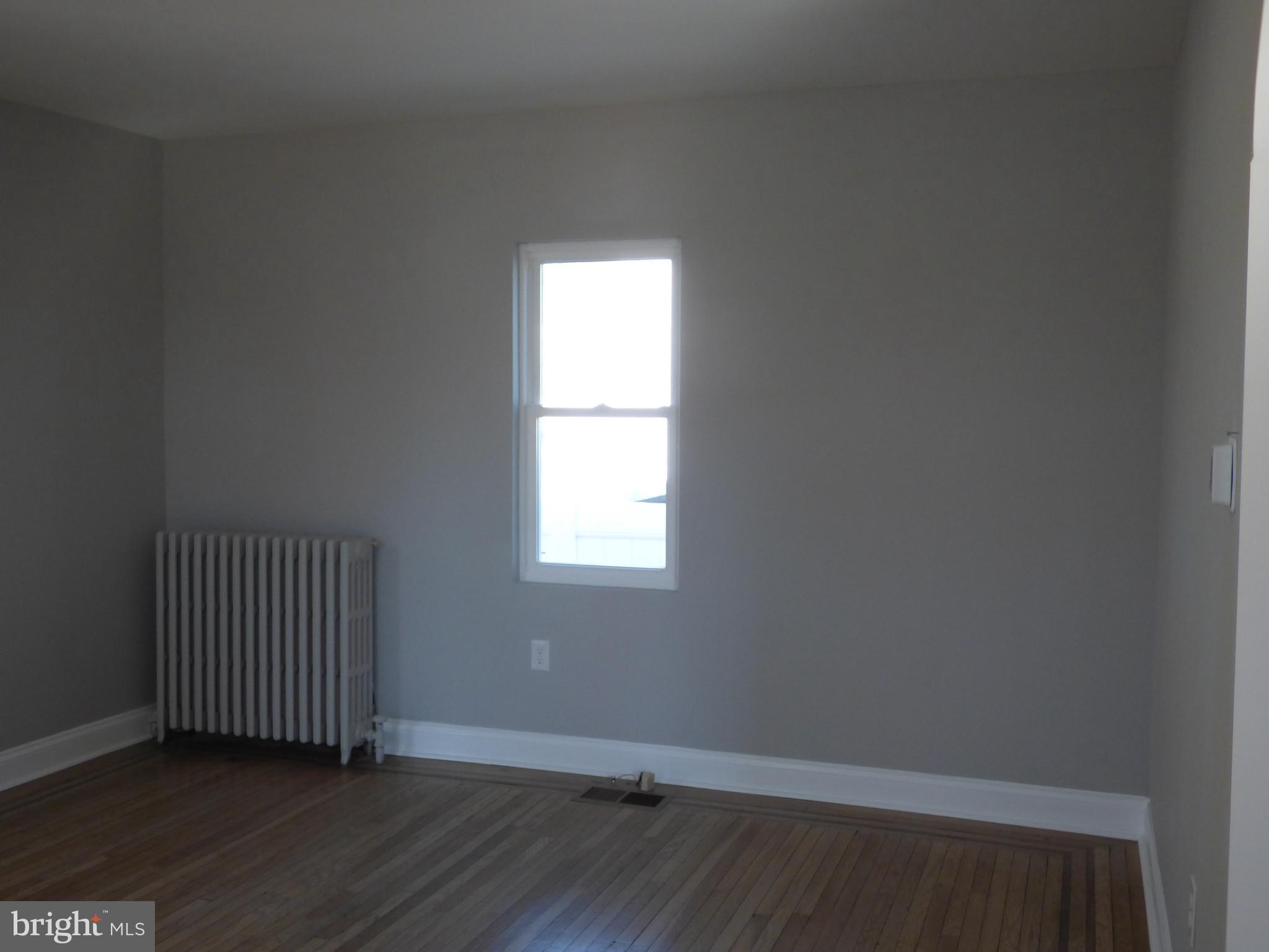 726 Newportville Road Croydon, PA 19021 - Photo 12 of 30 an empty room with wooden floor and windows