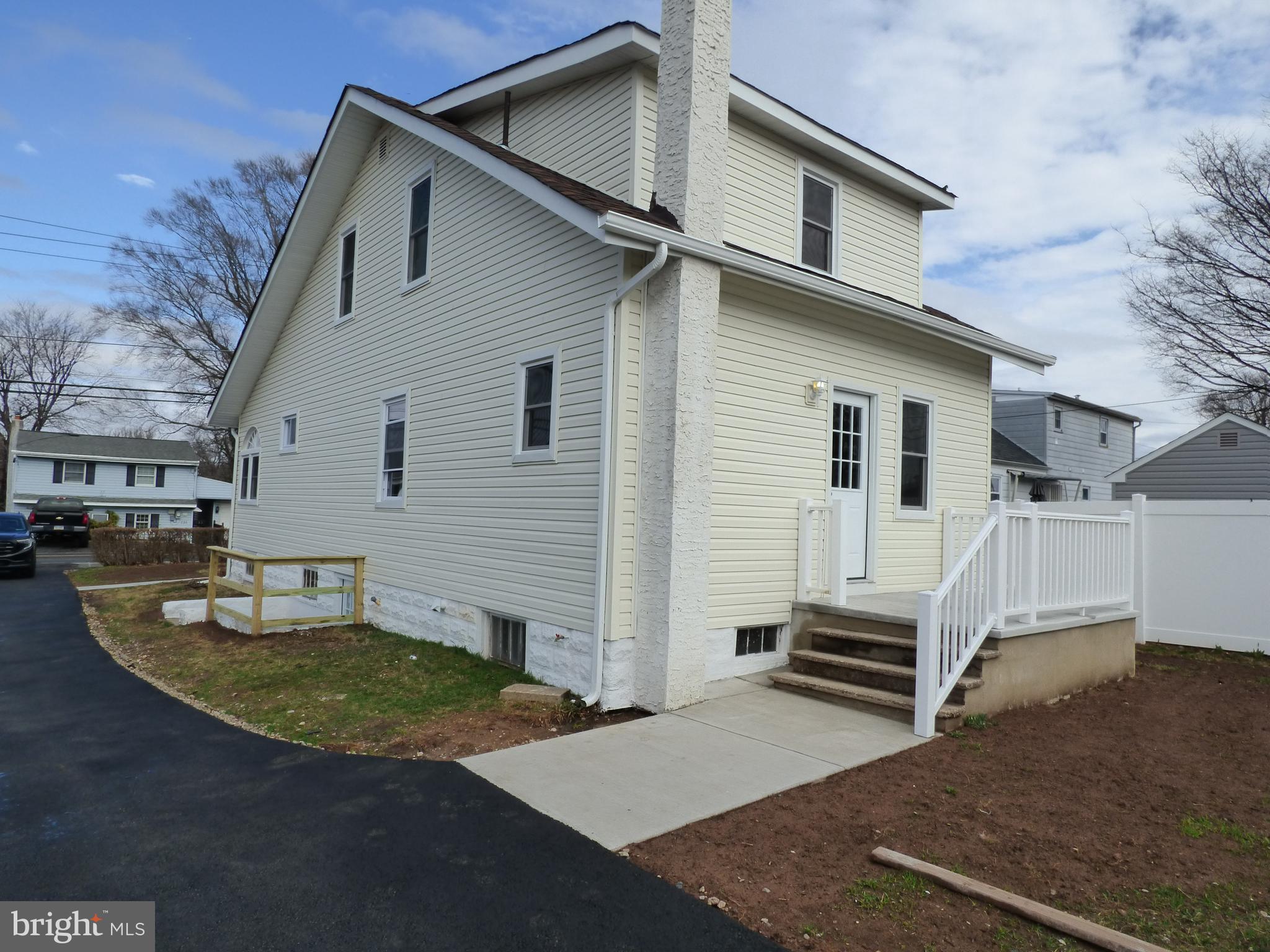 726 Newportville Road Croydon, PA 19021 - Photo 4 of 30 a view of a white house with a yard and lawn chairs