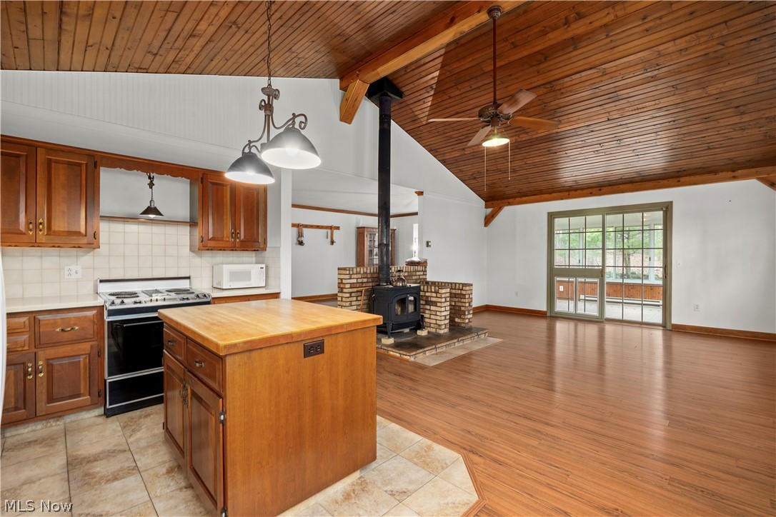 11923 Green Road Wakeman, OH 44889 - Photo 45 of 45 Kitchen with open floor plan, wood finish cabinets, wood counters, range with gas stovetop, and a high wooden beamed ceiling
