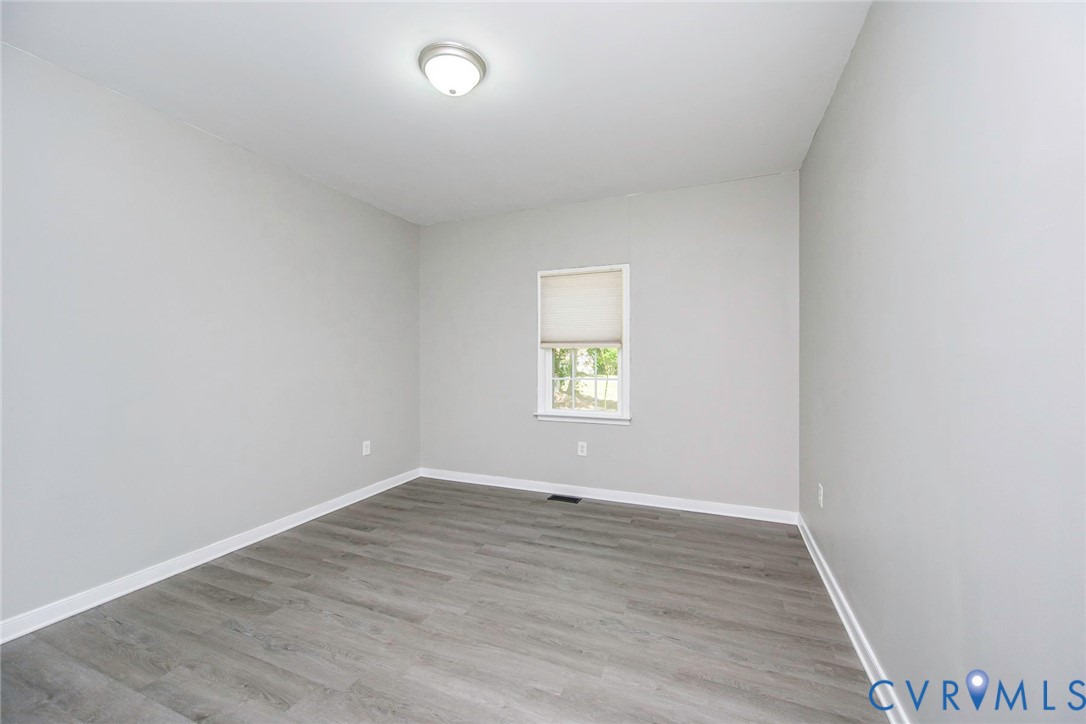 1297 Manfield Road Aylett, VA 23009 - Photo 26 of 41 an empty room with wooden floor and windows