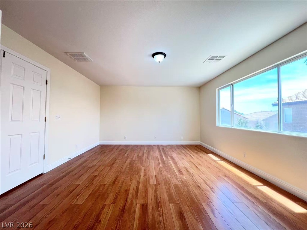 9891 Ridge Hill Avenue Las Vegas, NV 89147 - Photo 16 of 29 Rich hardwood flooring creates a warm foundation in this inviting, naturally lit room.