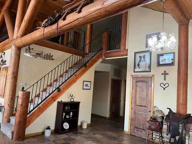 a kitchen with a sink a large window cabinets and stainless steel appliances