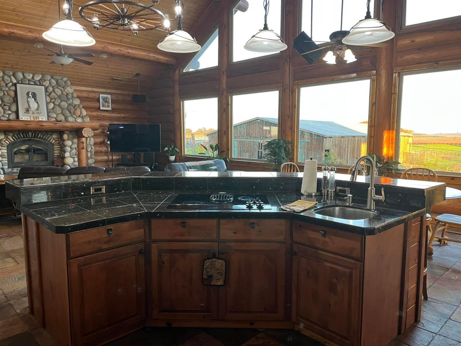 29266 Dry Creek Road Galt, CA 95632 - Photo 7 of 44 a kitchen with a sink a large window cabinets and stainless steel appliances