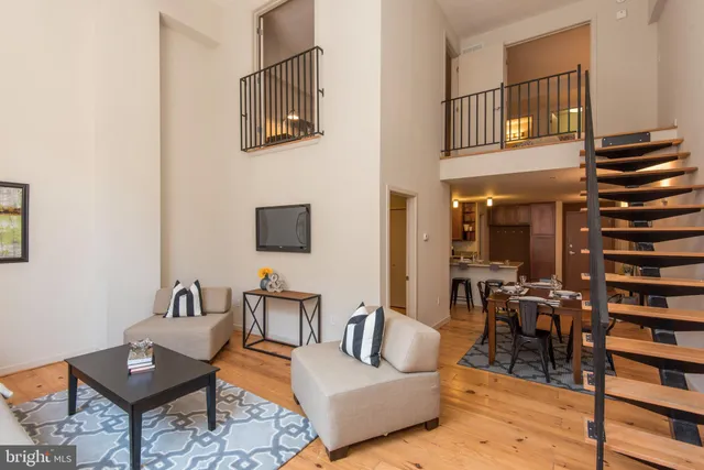 a living room with furniture and a book shelf