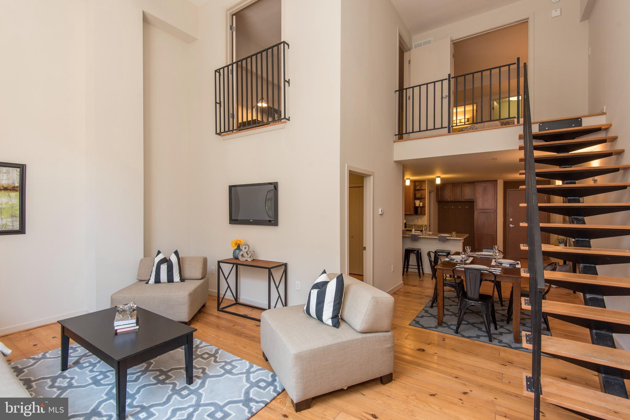 a living room with furniture and a book shelf