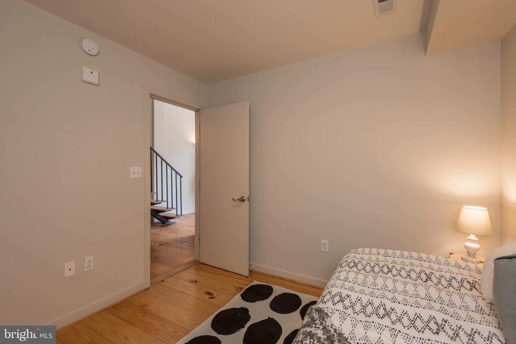 1200 Walnut Street, Unit 203 Philadelphia, PA 19107 - Photo 14 of 27 a bedroom with a bed and cabinets