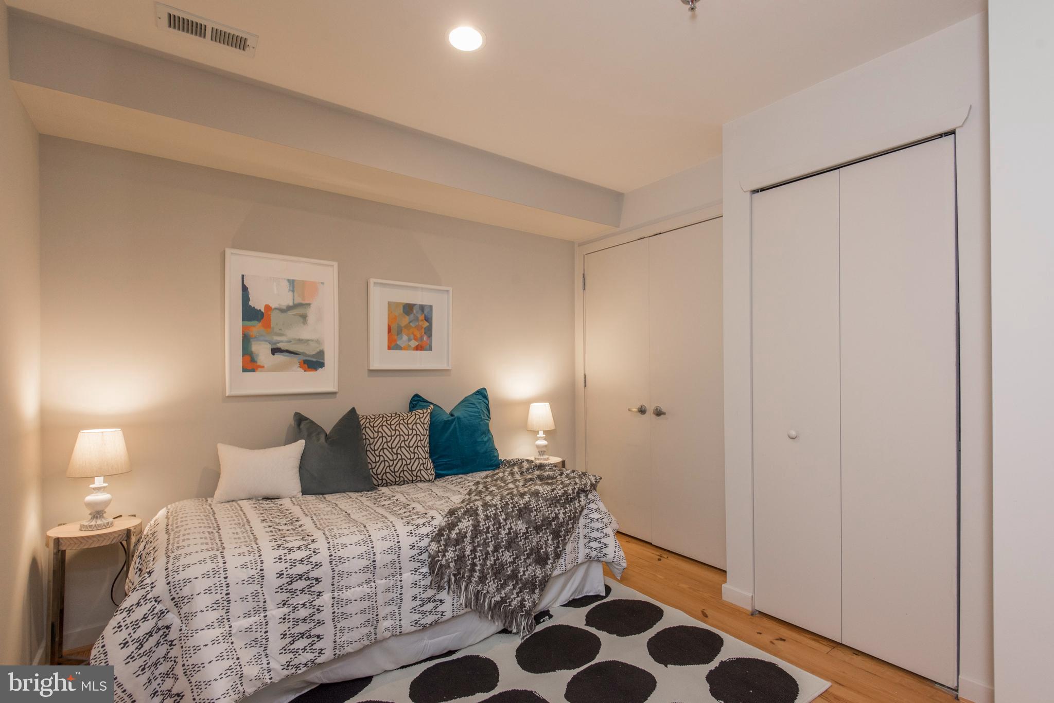 1200 Walnut Street, Unit 203 Philadelphia, PA 19107 - Photo 15 of 27 a bedroom with a bed and lamps