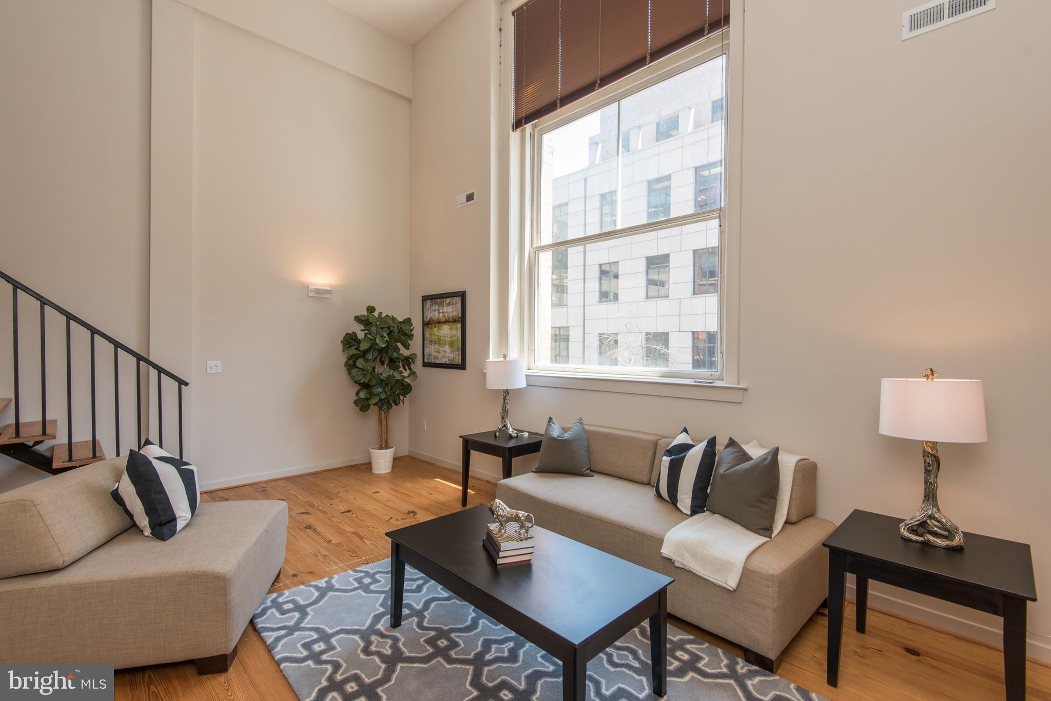 1200 Walnut Street, Unit 203 Philadelphia, PA 19107 - Photo 17 of 27 a living room with furniture and a window