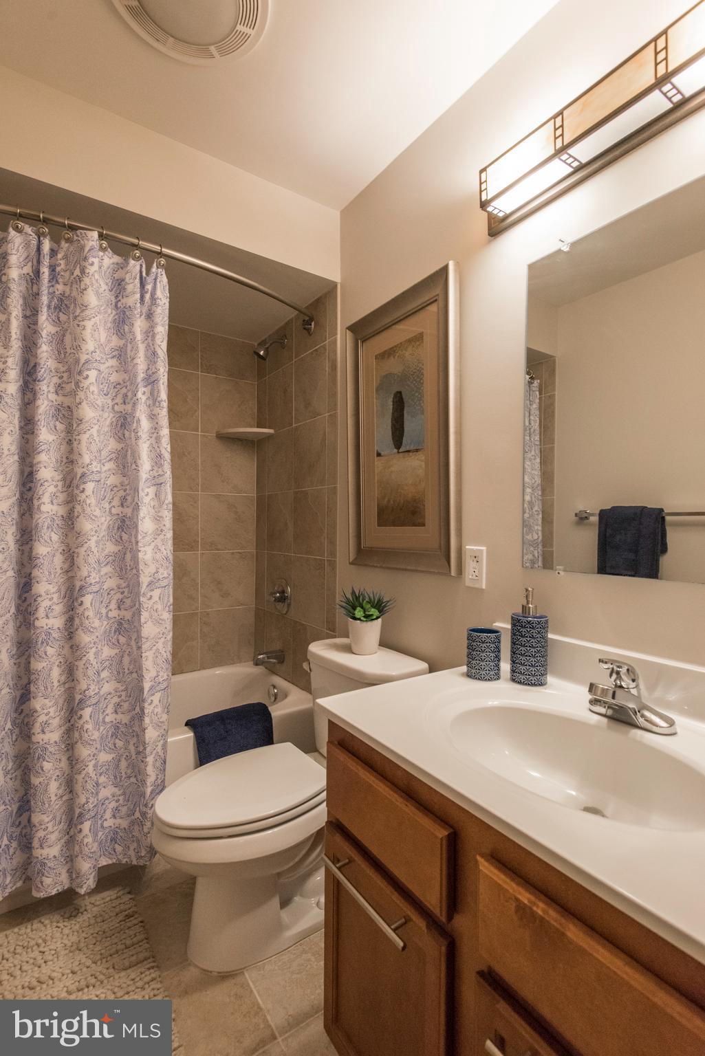 1200 Walnut Street, Unit 203 Philadelphia, PA 19107 - Photo 23 of 27 a bathroom with a sink a toilet a mirror and shower
