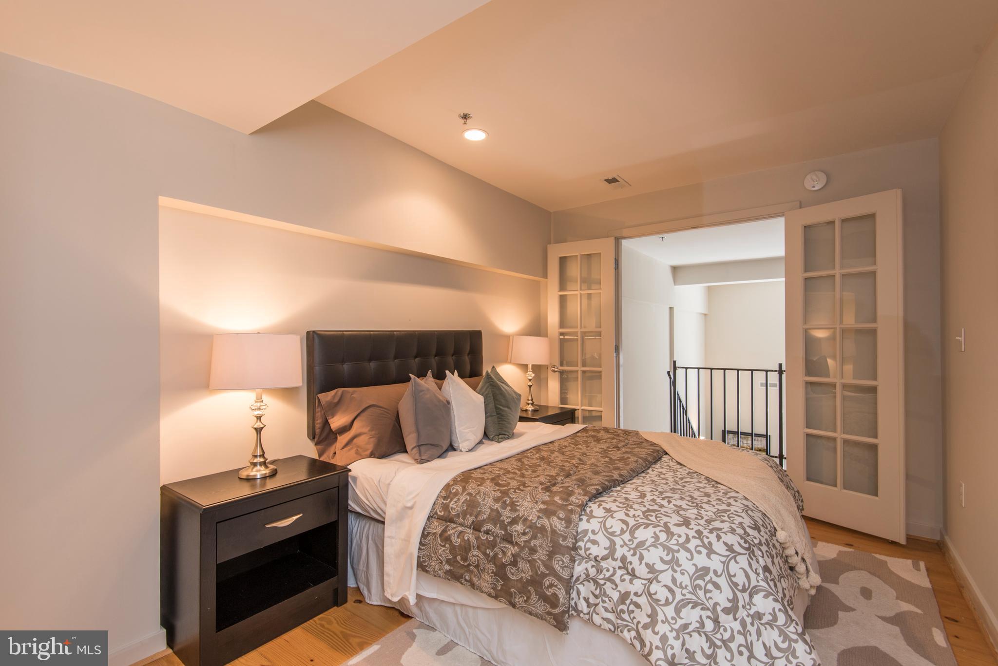 1200 Walnut Street, Unit 203 Philadelphia, PA 19107 - Photo 25 of 27 a bedroom with a bed and a window