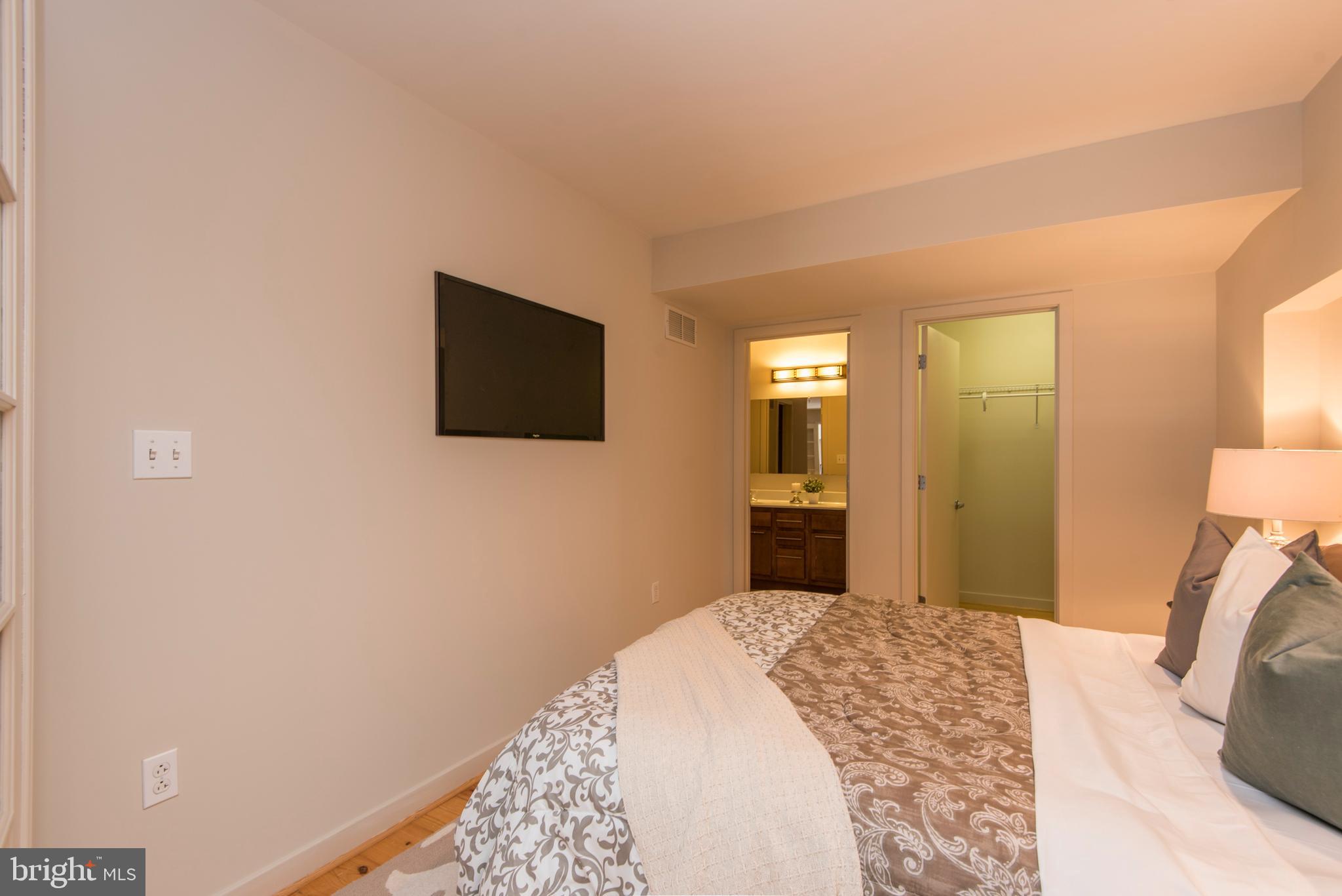 1200 Walnut Street, Unit 203 Philadelphia, PA 19107 - Photo 27 of 27 a bedroom with a bed and a flat screen tv