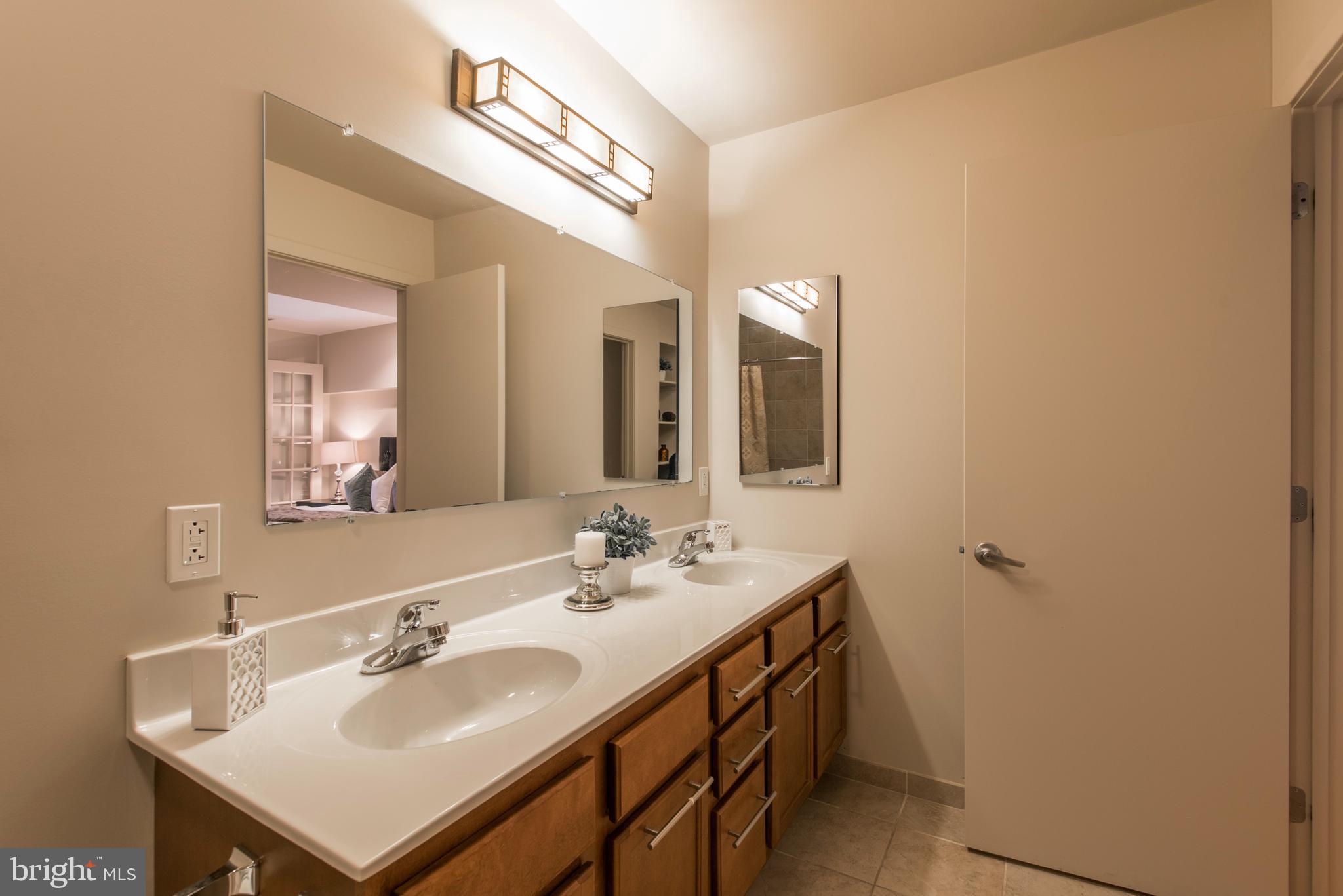 1200 Walnut Street, Unit 203 Philadelphia, PA 19107 - Photo 5 of 27 a bathroom with a sink and a mirror