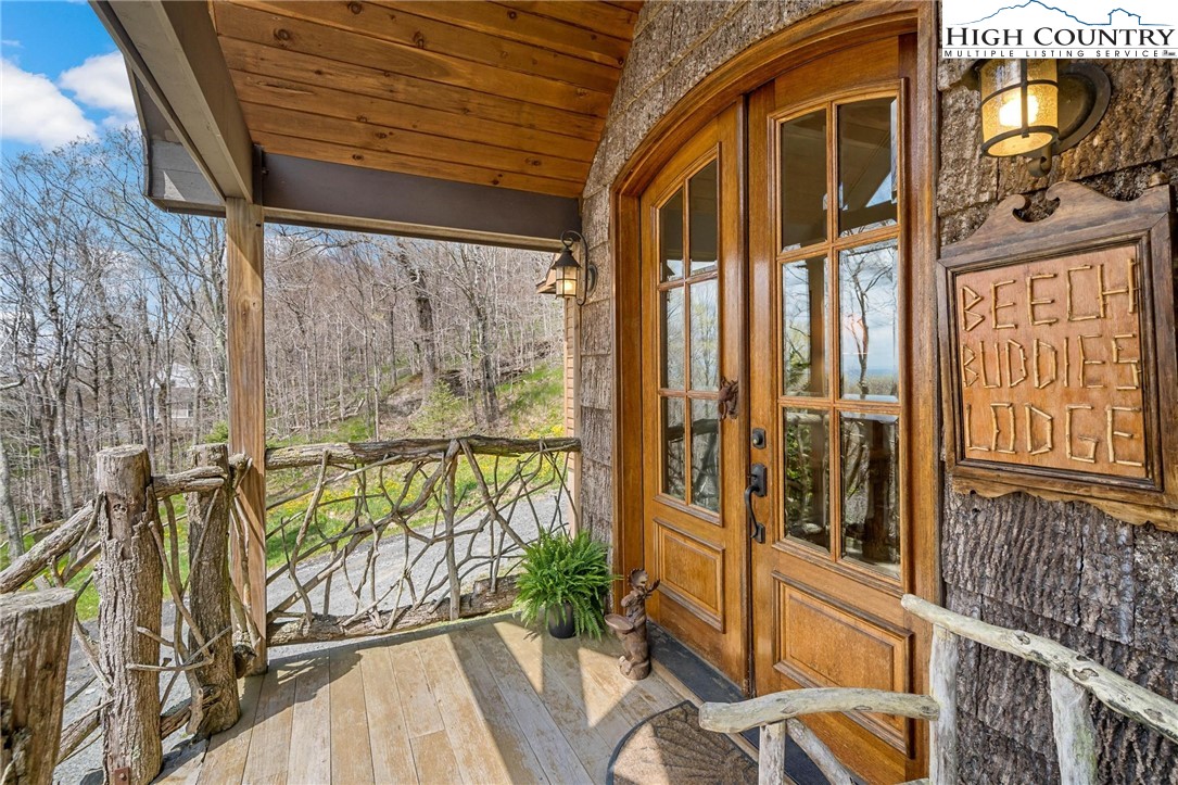 140 Spruce Hollow Road Beech Mountain, NC 28604 - Photo 22 of 50 a view of a porch with wooden floor and furniture