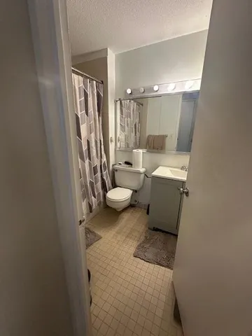 a living room with furniture and a toilet