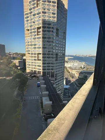 a view of balcony with floor to ceiling windows with wooden floor