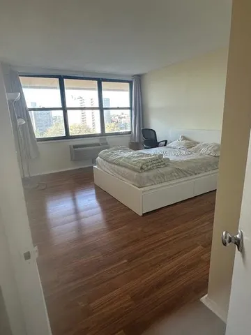 a living room with hard wood floors and window