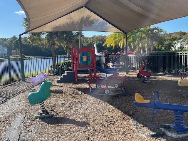 6536 South Goldenrod Road, Unit 67A Orlando, FL 32822 - Photo 14 of 14 a view of a patio with table and chairs under an umbrella