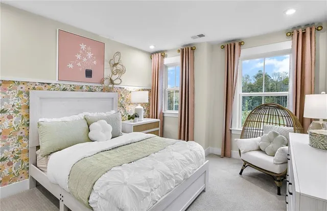 a bedroom with a bed and a large window