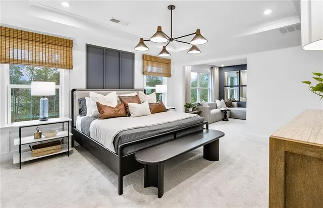 a spacious bedroom with a bed and a chandelier