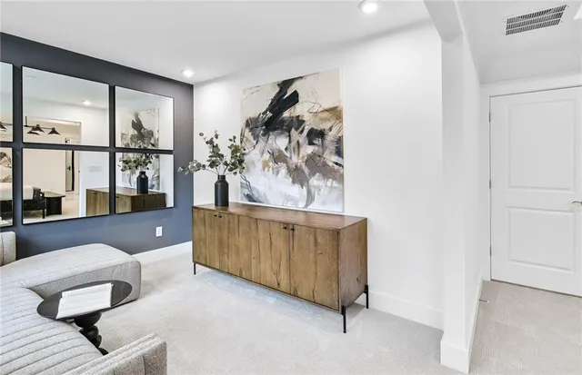 a living room with furniture and a floor to ceiling window
