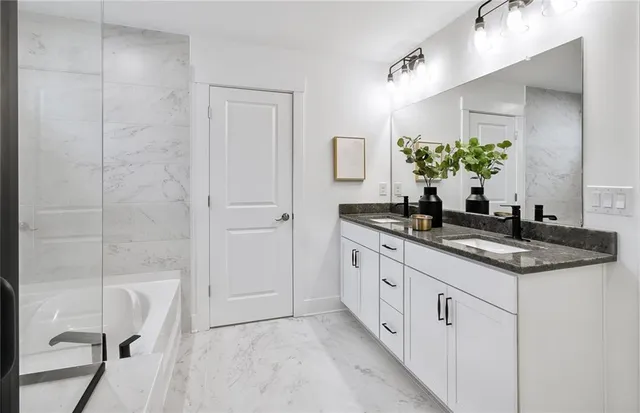 a bathroom with a granite countertop sink a mirror and a