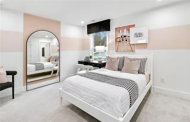 a bedroom with a bed and a mirror