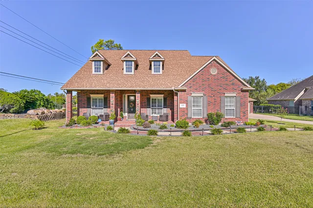 a front view of a house with swimming pool having outdoor seating