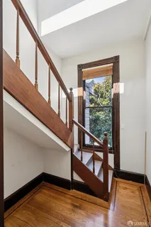 a view of a room with wooden floor and windows