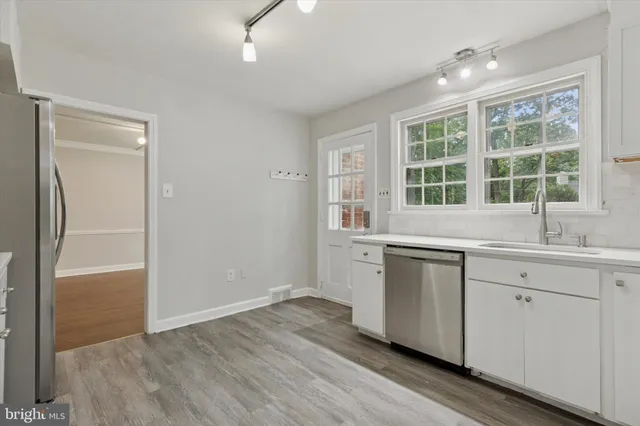 a kitchen with a sink and wide window