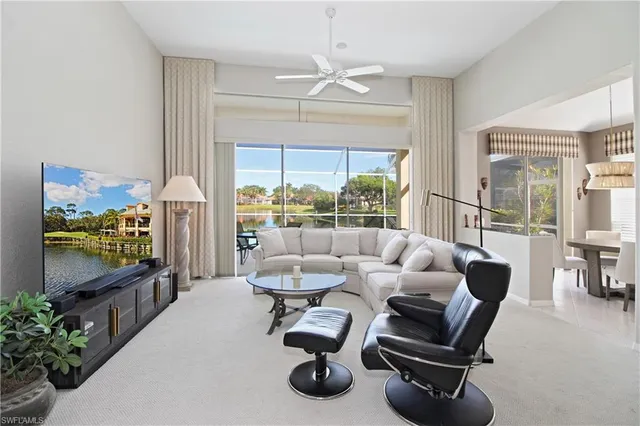 a kitchen with a white cabinets and chairs