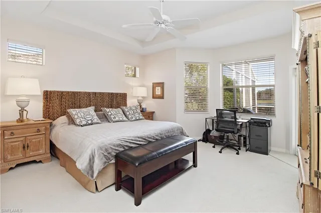 a spacious bedroom with a bed and a chandelier