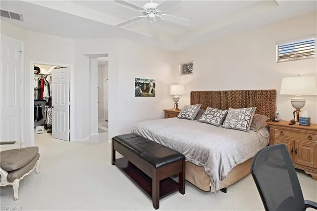 a bedroom with a bed and a lamp