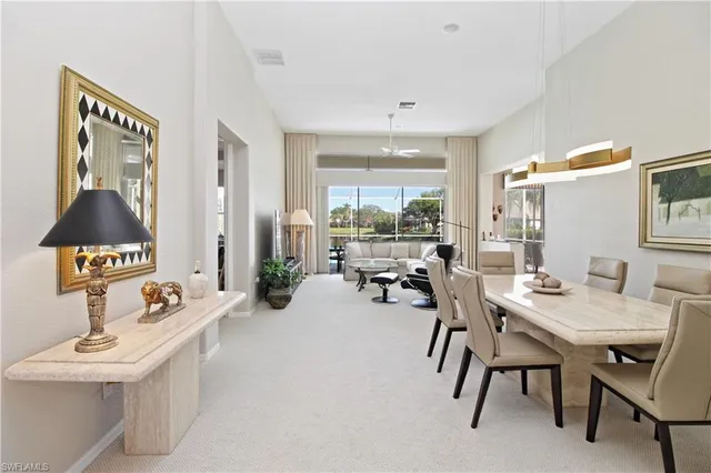 a view of a dining room with furniture and a chandelier